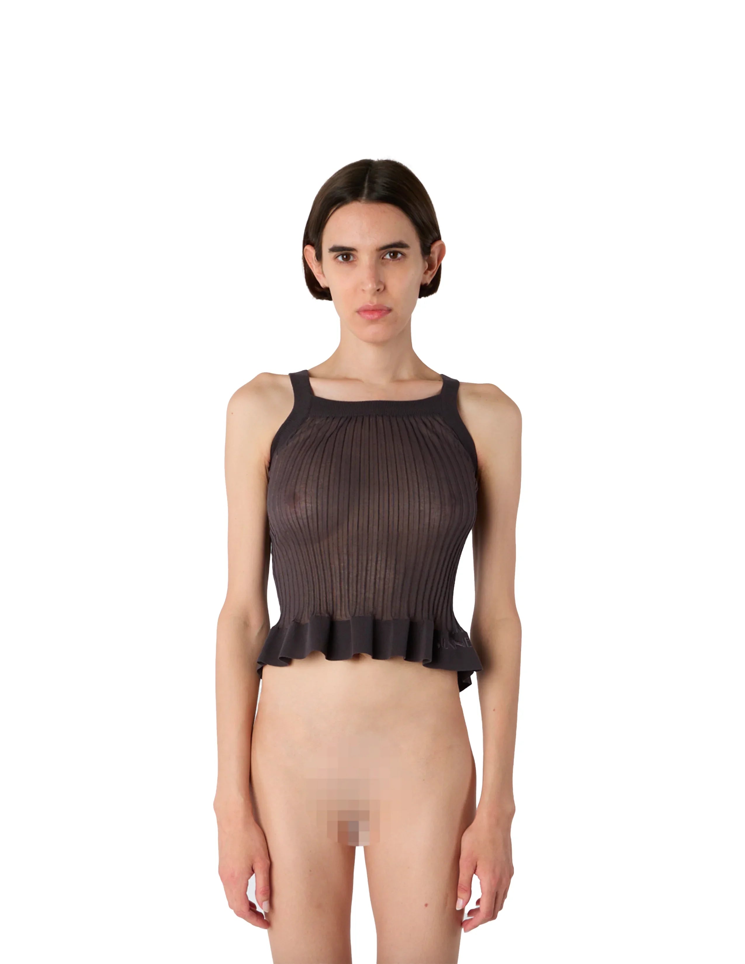 Front view of a woman wearing a black ribbed knit tank top with ruffle hem on white background