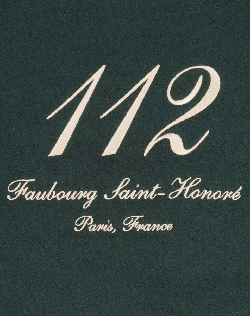 Embossed design with '112 Faubourg Saint-Honoré Paris, France' in elegant white script on dark background