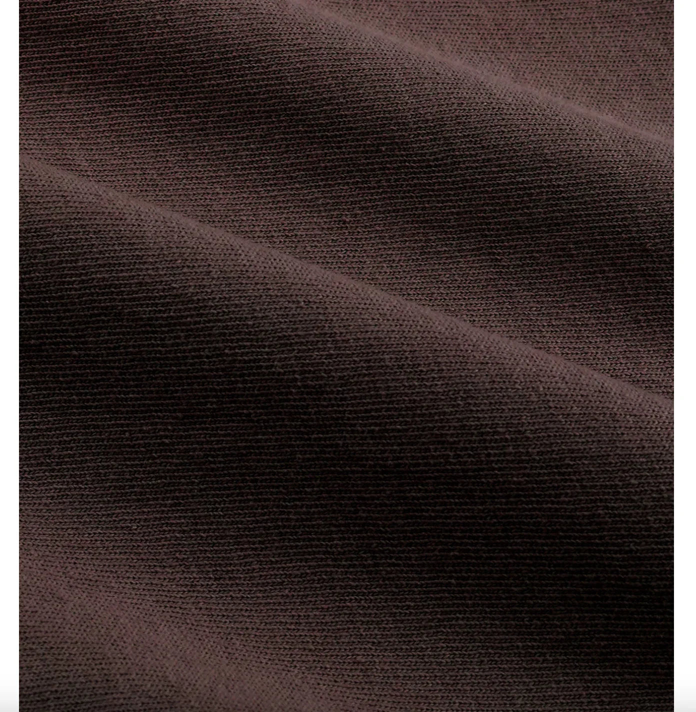 Close-up of dark brown ribbed knit fabric with soft folds and texture