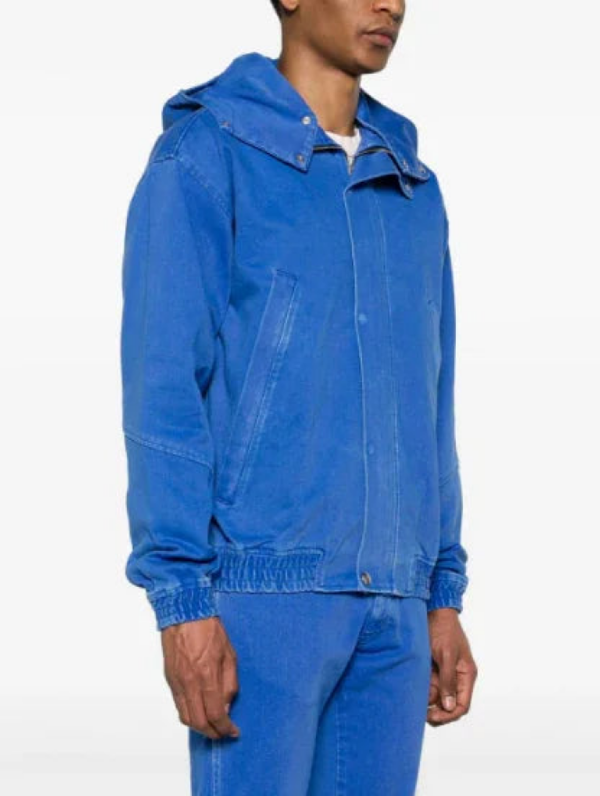 Man wearing a vibrant blue hooded jacket with front pockets and matching blue pants