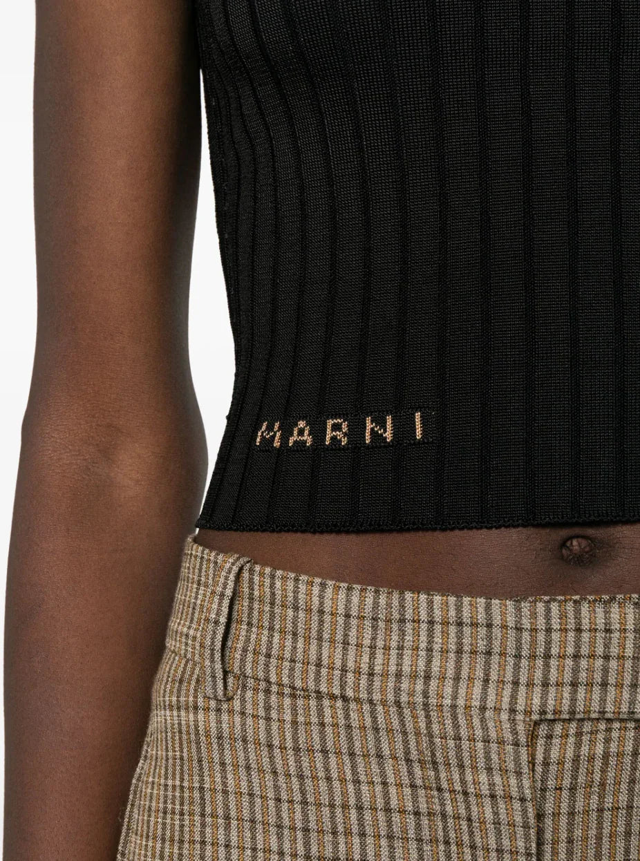 Close-up of ribbed black Marni crop top and high-waisted checkered brown plaid pants