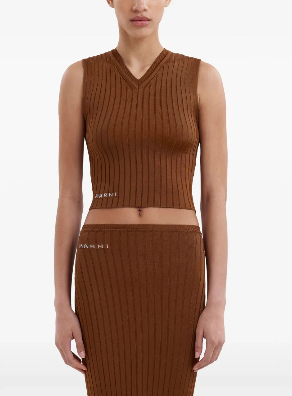 Woman wearing brown ribbed sleeveless crop top and matching skirt with Marni logo
