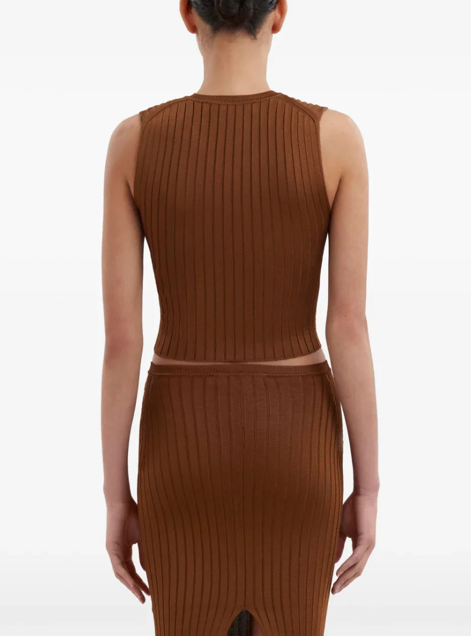 Back view of woman wearing brown ribbed knit sleeveless crop top and matching skirt against white background