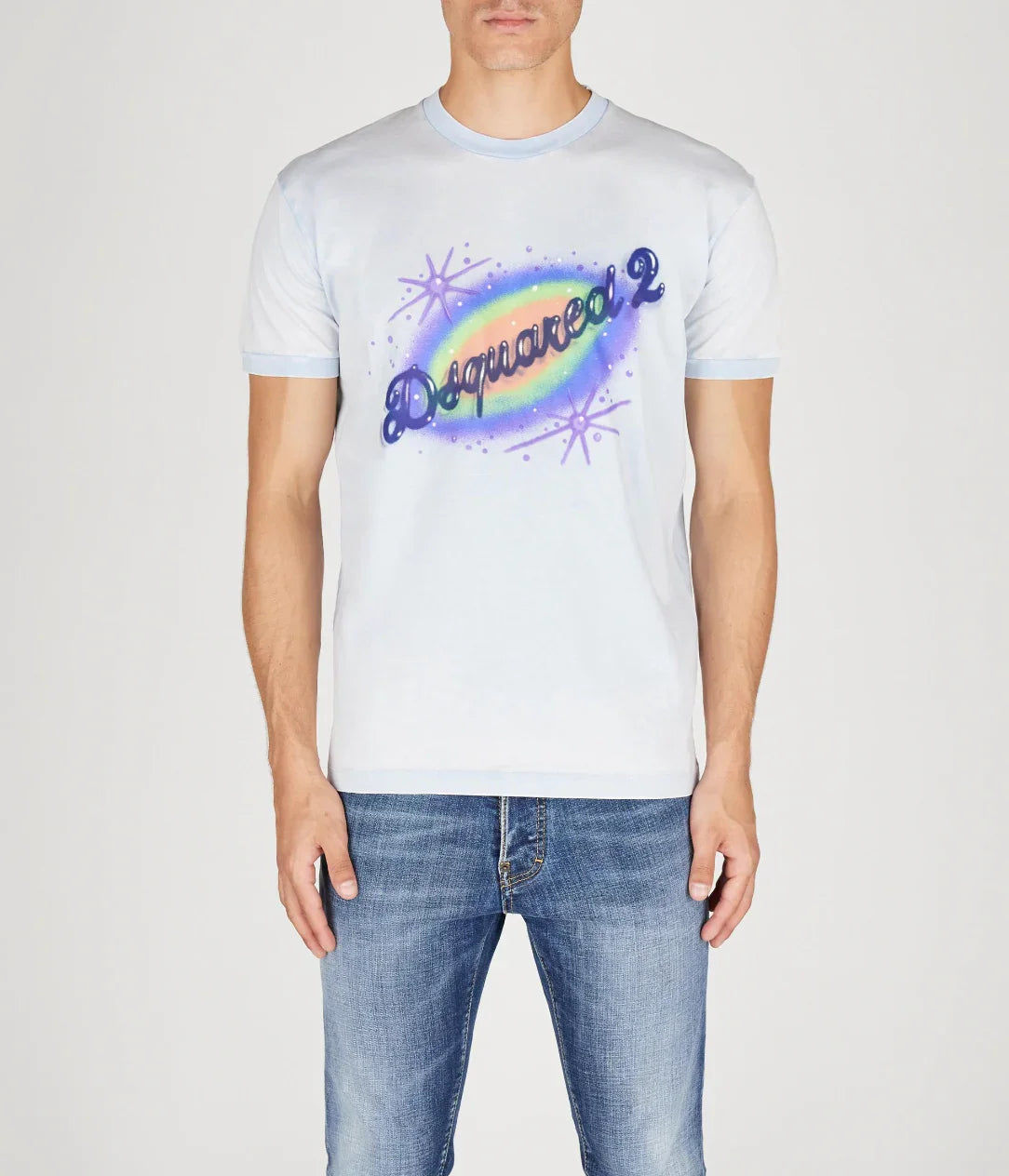Man wearing light blue Dsquared2 graphic t-shirt with rainbow and starburst design, paired with blue jeans