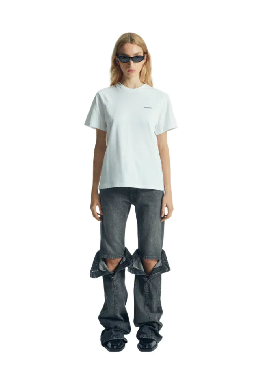 Woman wearing white t-shirt and unique black detachable jeans with sunglasses on white background