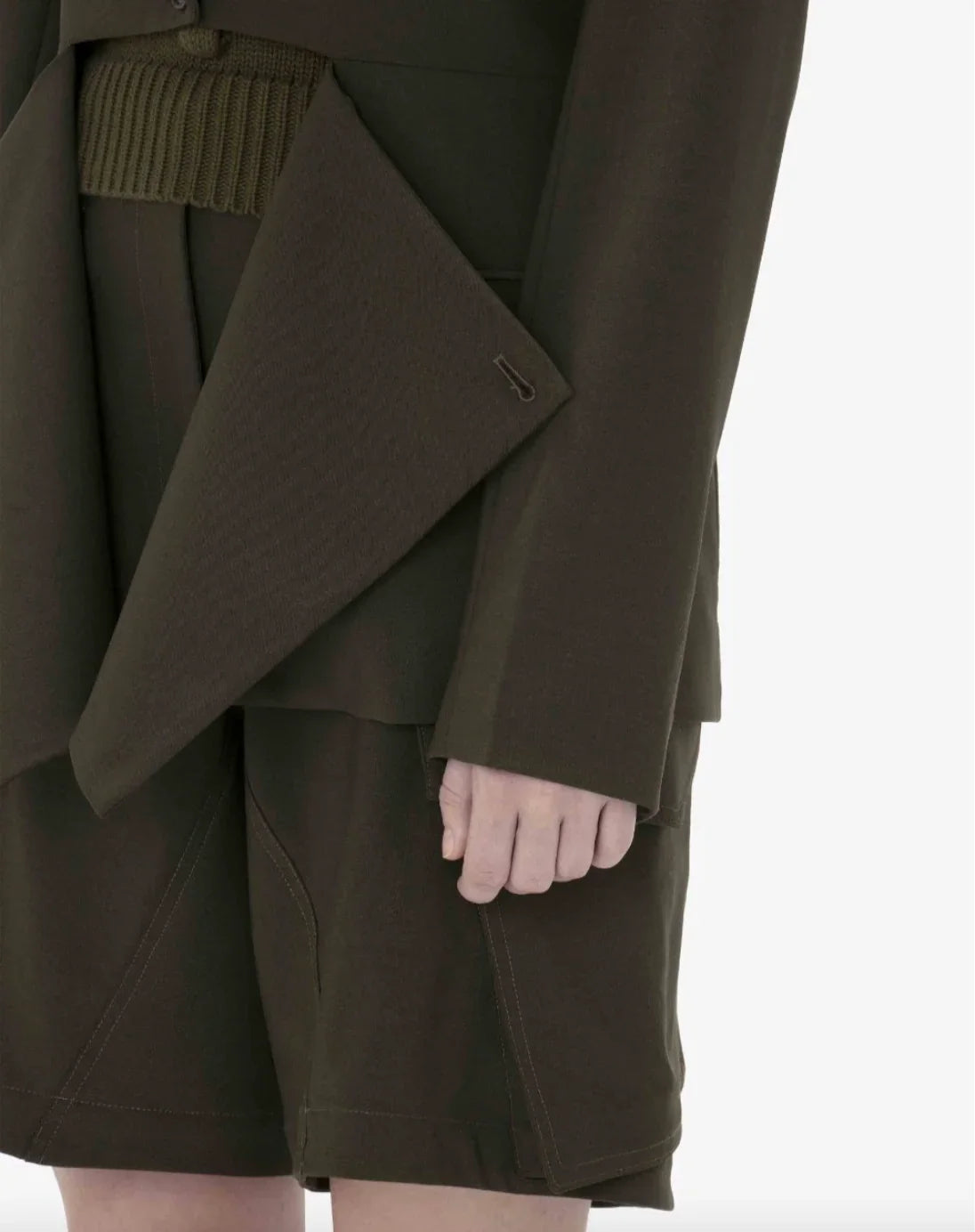 Close-up of dark brown tailored jacket with large lapel and matching shorts on model