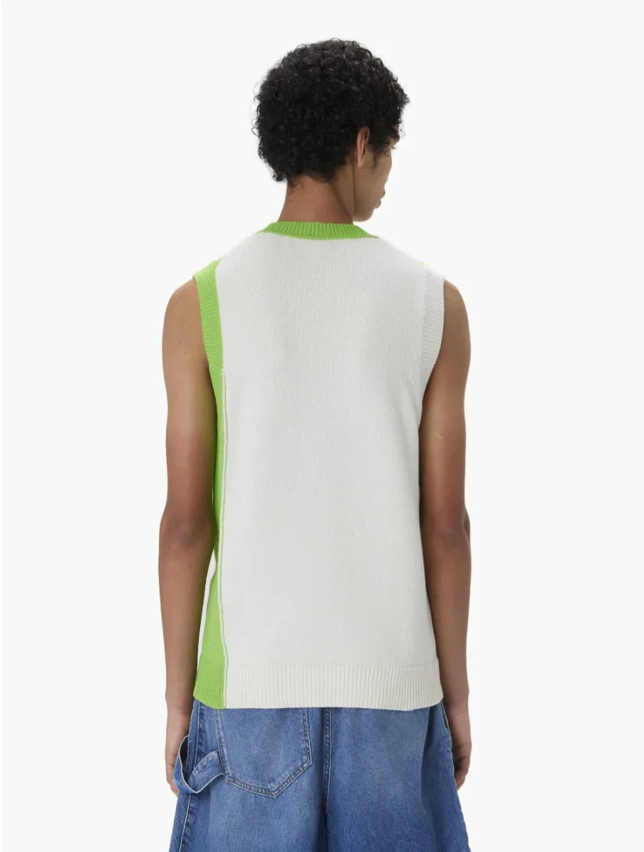 Back view of a person wearing a sleeveless white and green knitted sweater vest with blue denim shorts