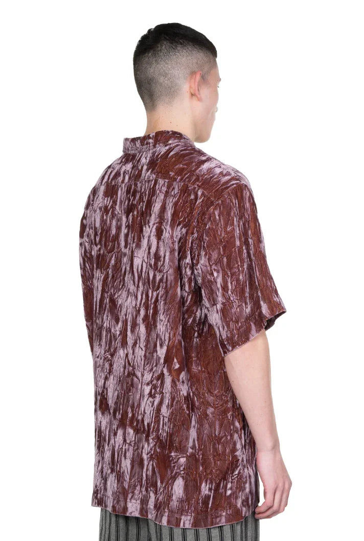 Back view of a man wearing a textured brown crushed velvet short-sleeve shirt