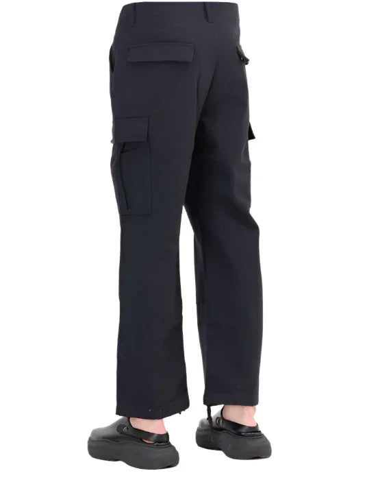 Back view of black cargo pants with multiple pockets and black casual shoes