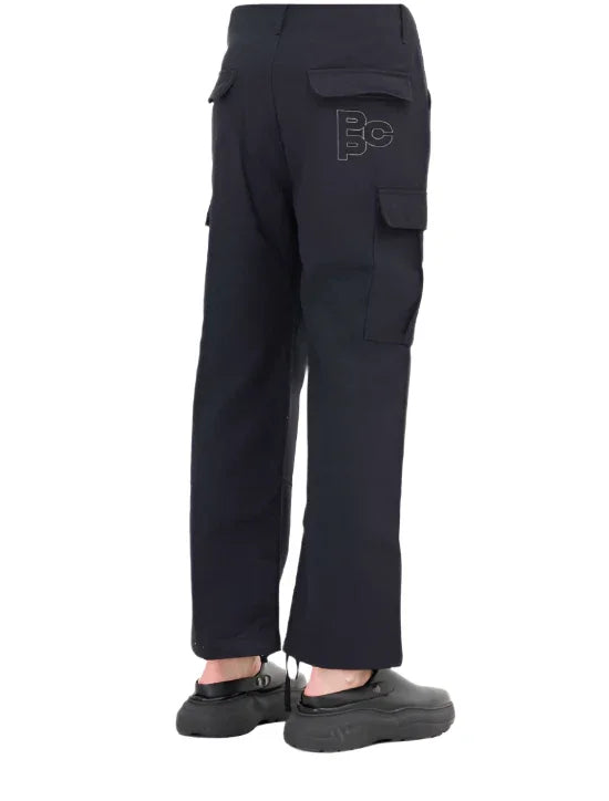 Black cargo pants with multiple pockets and logo on back pocket, worn with black shoes
