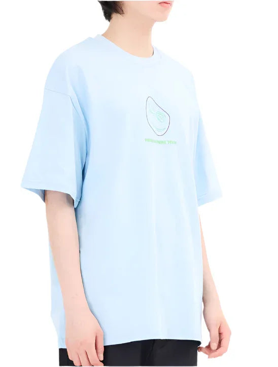 Person wearing a light blue graphic t-shirt with a green avocado design and black pants on white background