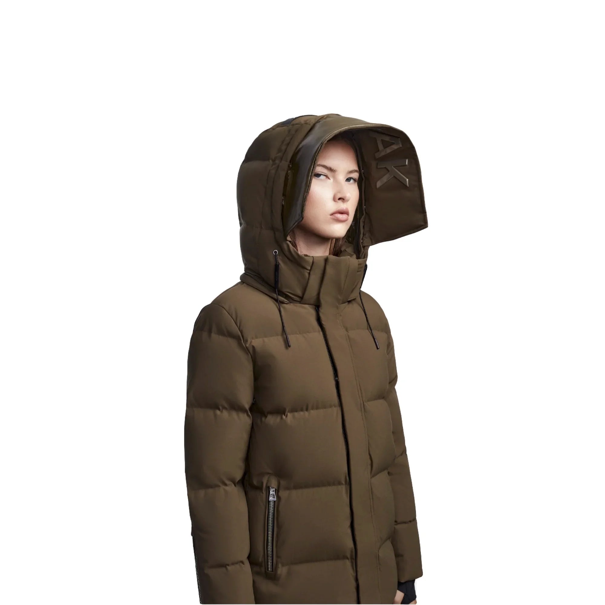 Woman wearing olive green puffer jacket with large insulated hood and zipper pockets