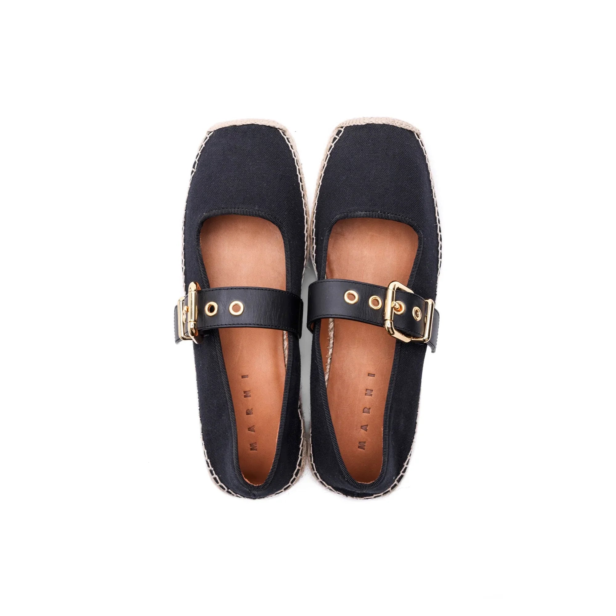 Pair of black Marni espadrilles with leather straps and gold buckles on white background