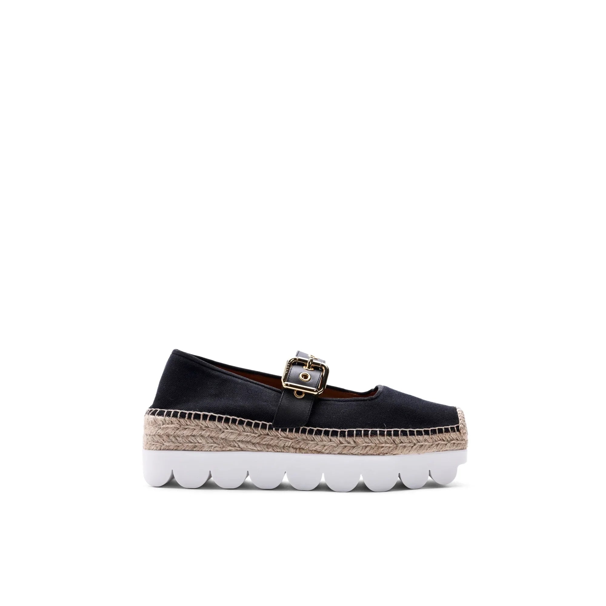 Black canvas espadrille shoe with gold buckle, woven jute midsole, and thick white scalloped rubber outsole