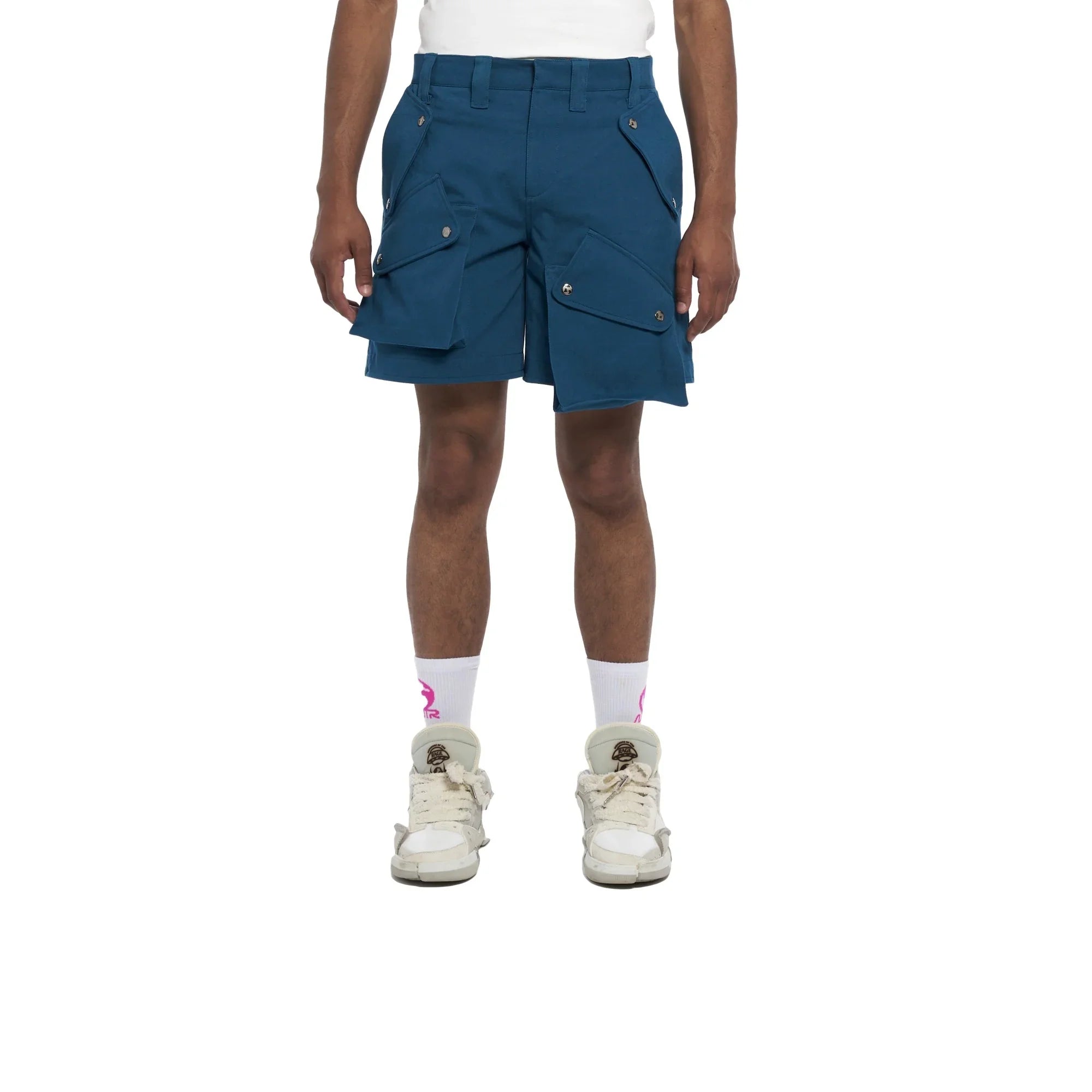 Man wearing blue cargo shorts with multiple snap pockets, white socks, and white sneakers