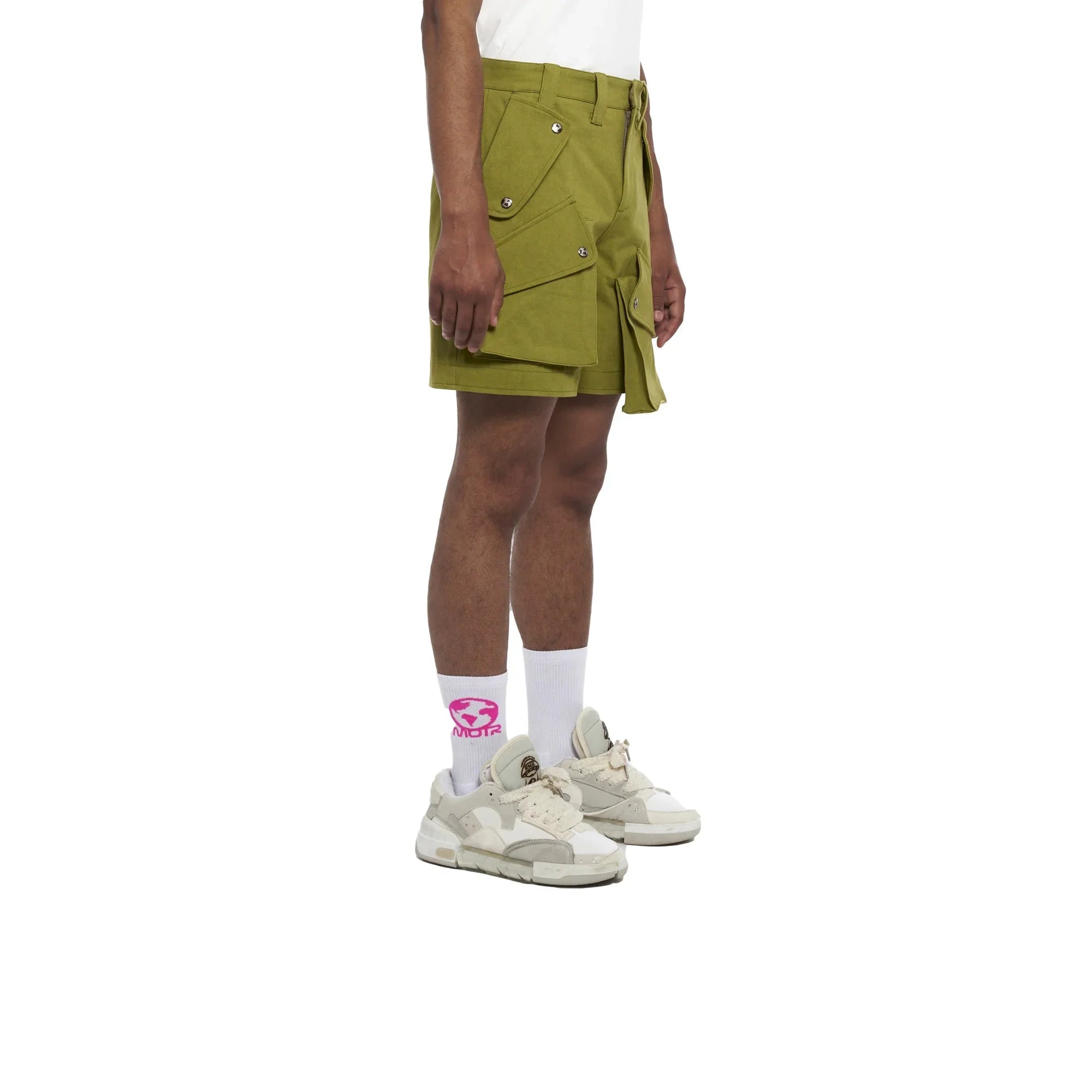 side view of person wearing olive green cargo shorts with multiple pockets, white socks, and white sneakers