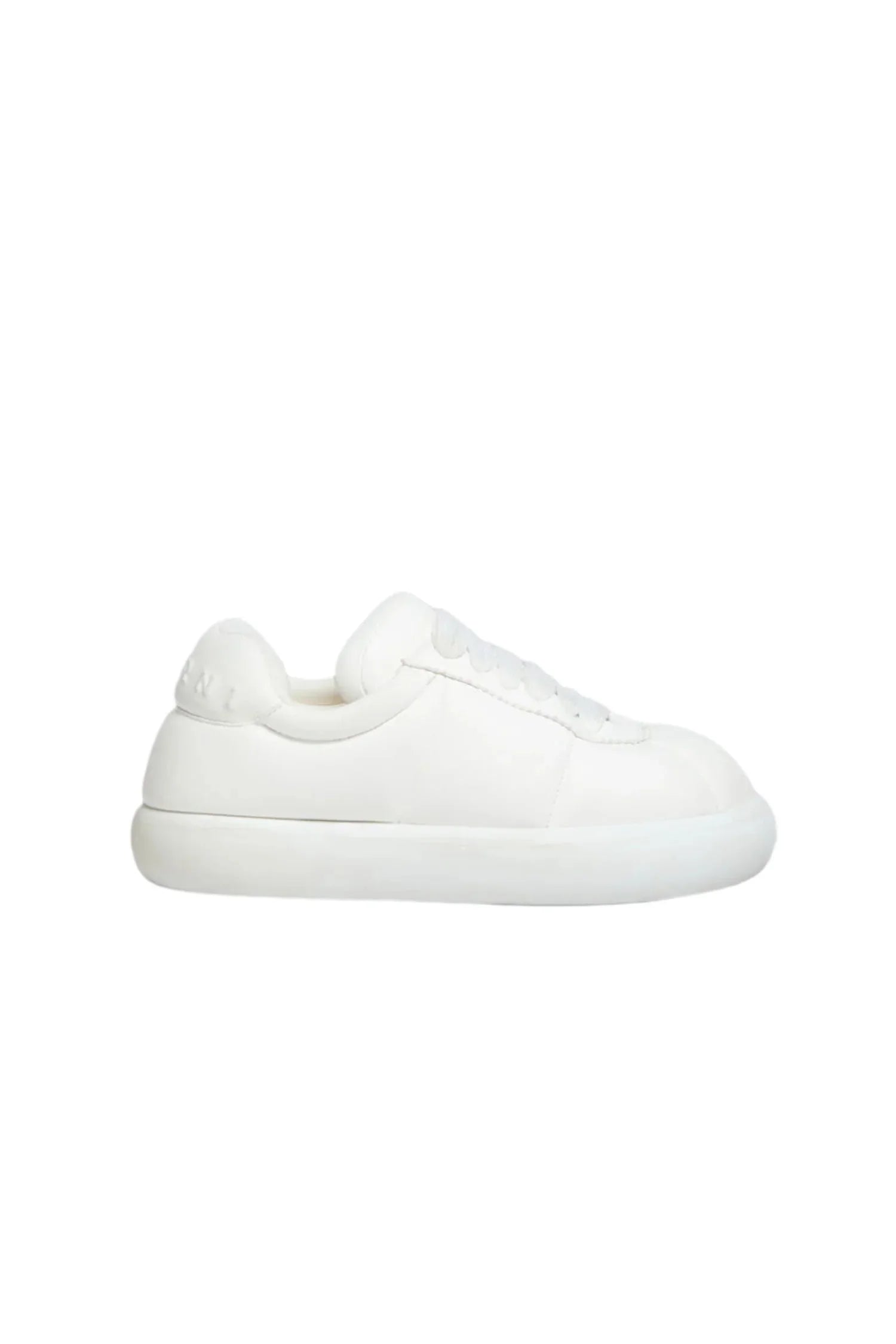 Minimalist all-white leather sneaker with thick sole and subtle stitching