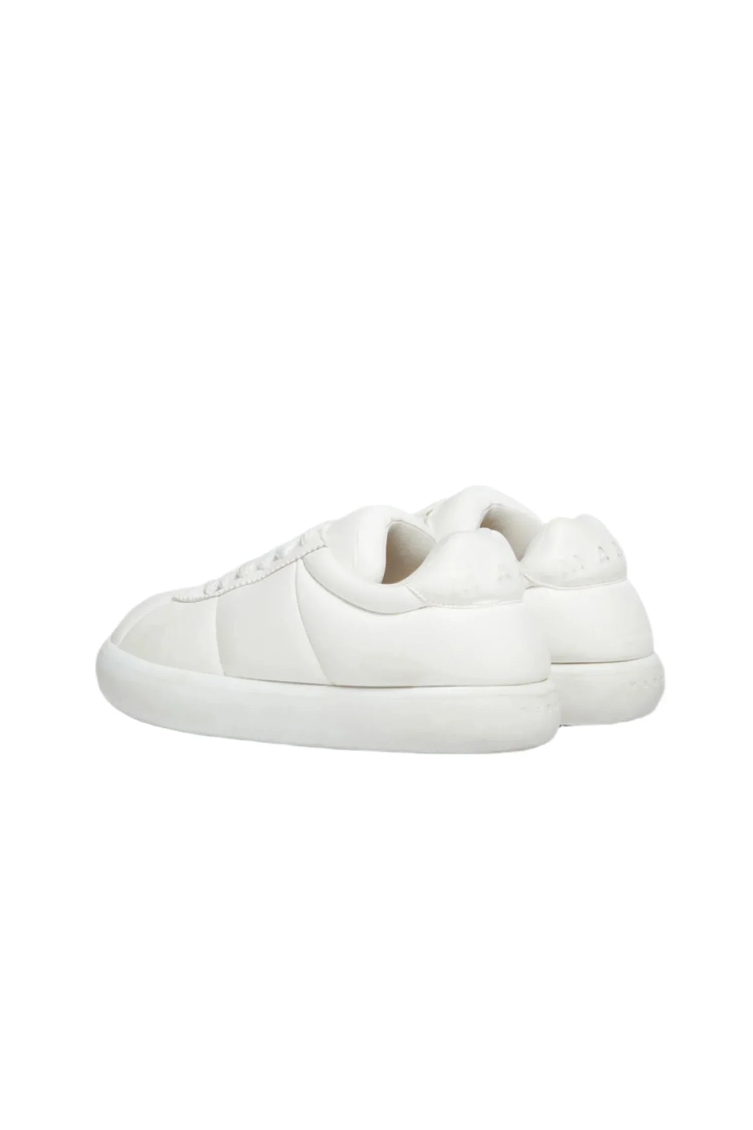 Pair of minimalist white low-top sneakers with clean design and rubber soles on white background