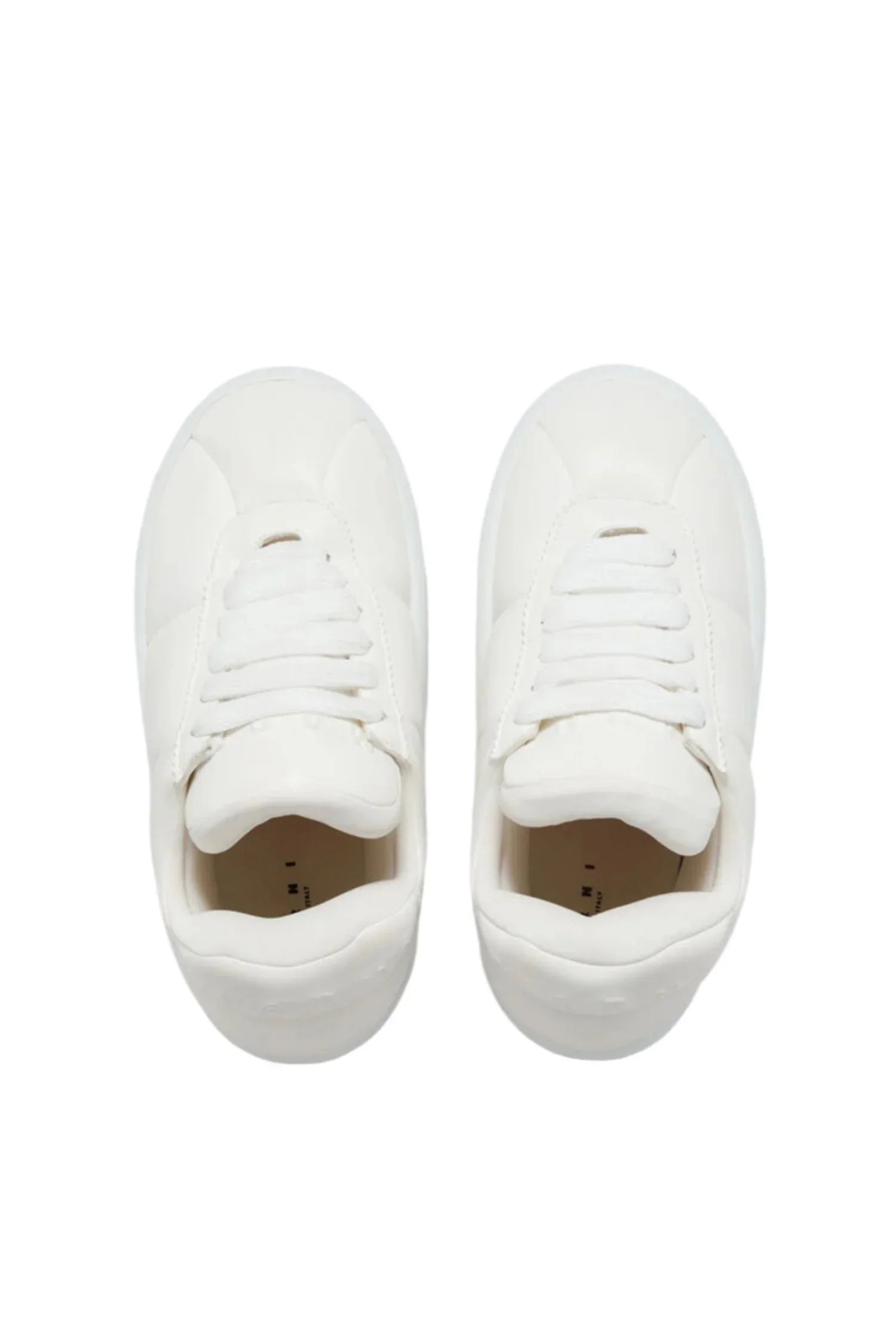 Top view of white classic leather sneakers with white laces on plain background